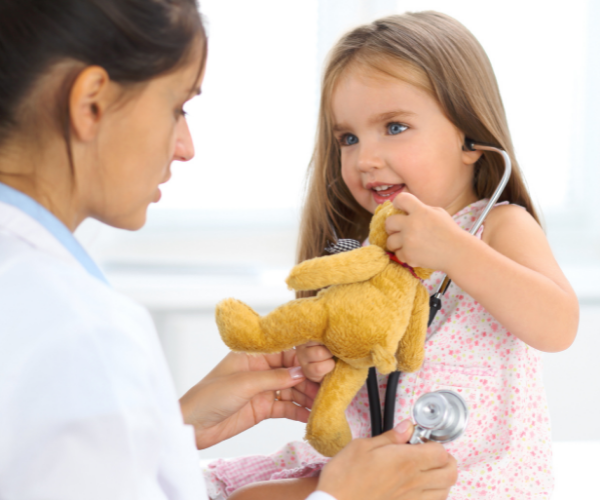little girl being examined by a doctor 
